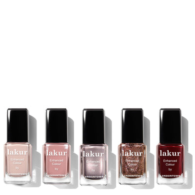 Five bottles from the Holiday Luxe Collection by LONDONTOWN, showcasing assorted shades, are arranged in a row on a white background.