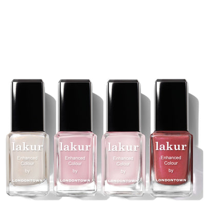 The Petals & Pearls Set by LONDONTOWN features four nail polish bottles in soft shades of white, light pink, pale pink, and red, elegantly lined up on a white background to capture everyday beauty.