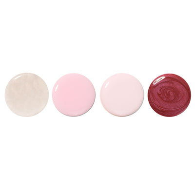 The Petals & Pearls Set by LONDONTOWN features four round blobs of nail polish in shimmering soft hues: beige, pink, light pink, and red, displayed in a row on a white background.