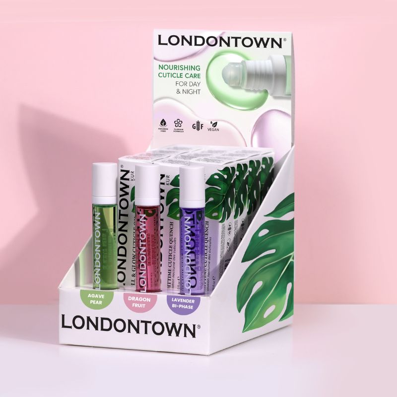 Showcase of LONDONTOWN Cuticle Oil POP Display in diverse fragrances, including Agave Pear and Lavender, set against a pink backdrop.