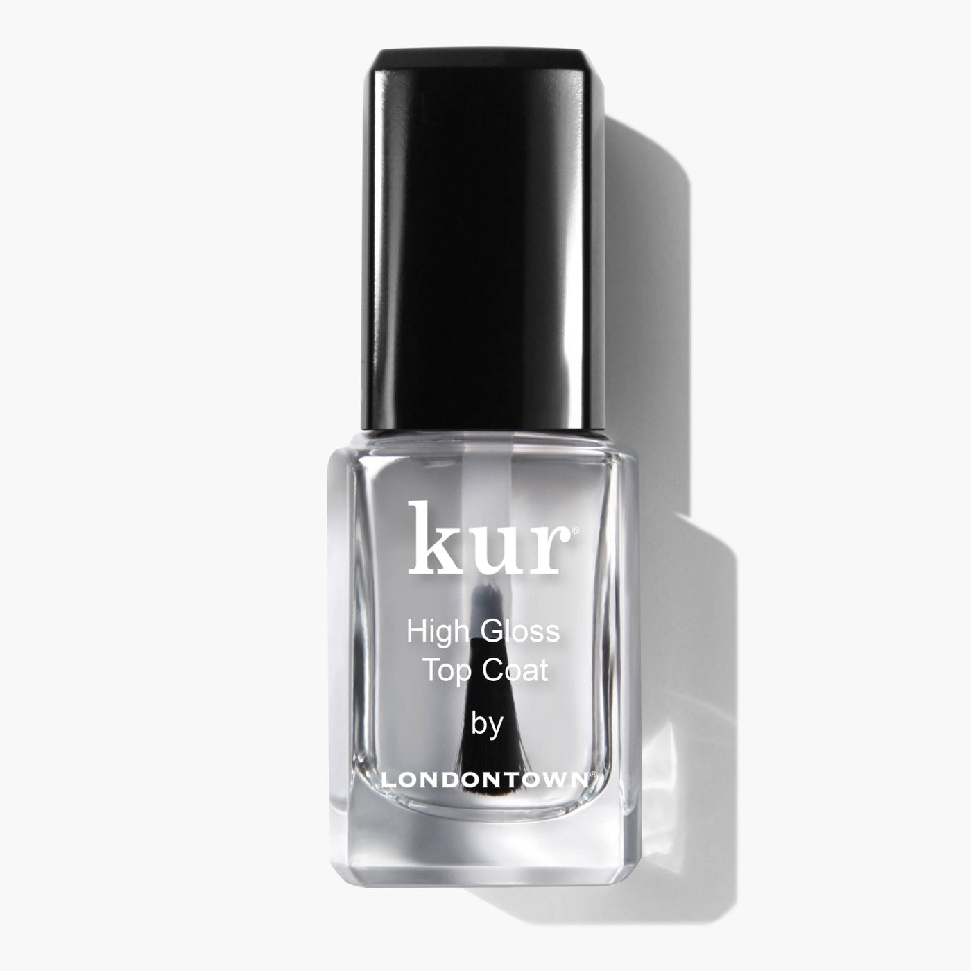A bottle of High Gloss Top Coat (Professional) by LONDONTOWN, featuring a black cap and casting a shadow on a white background, provides an ultra-shiny finish that captivates the eye.