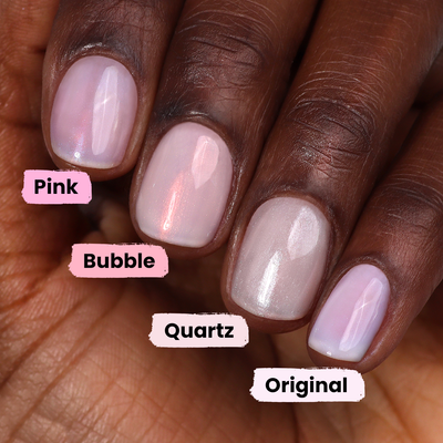 Close-up of a hand showing four fingernails painted in different shades of LONDONTOWN's Pink Illuminating Nail Concealer, each with a unique pink finish labeled as Pink, Bubble, Quartz, and Original.