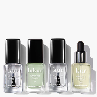 Four bottles of nail care products from LONDONTOWN's All the Sage Mani Set: Nail Hardener & Base Coat, a light green Enhanced Colour perfect for the spring season, High Gloss Top Coat, and Nourishing Cuticle Oil.