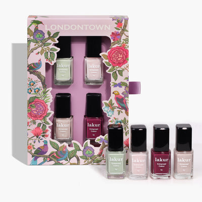 The Spring Fling Lakur Set by LONDONTOWN features five nail polishes in a variety of vibrant colors, beautifully presented in an open floral-patterned box. Three of the stylish bottles stand prominently in front, making the display reminiscent of a lovely bouquet.