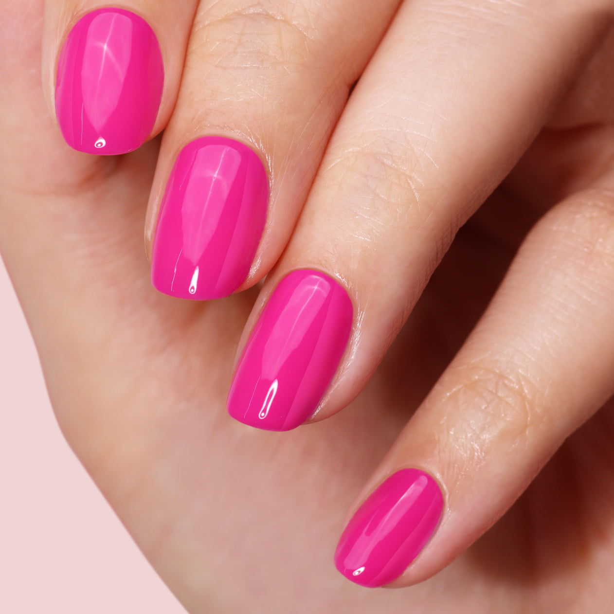 A close-up of neatly manicured nails painted in glossy bright pink using the LONDONTOWN Mini Mani Kit - Mother's Day Set, perfect for manis on the go.