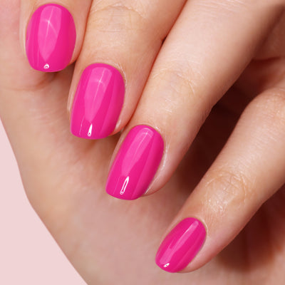 A close-up of neatly manicured nails painted in glossy bright pink using the LONDONTOWN Mini Mani Kit - Mother's Day Set, perfect for manis on the go.