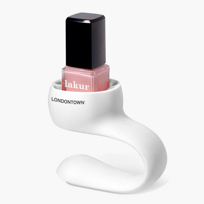 A bottle of LONDONTOWN Lakur nail polish is displayed in a Bottle Service Polish Holder, set against a plain background, ensuring easy manicures and mess-free pedicures.