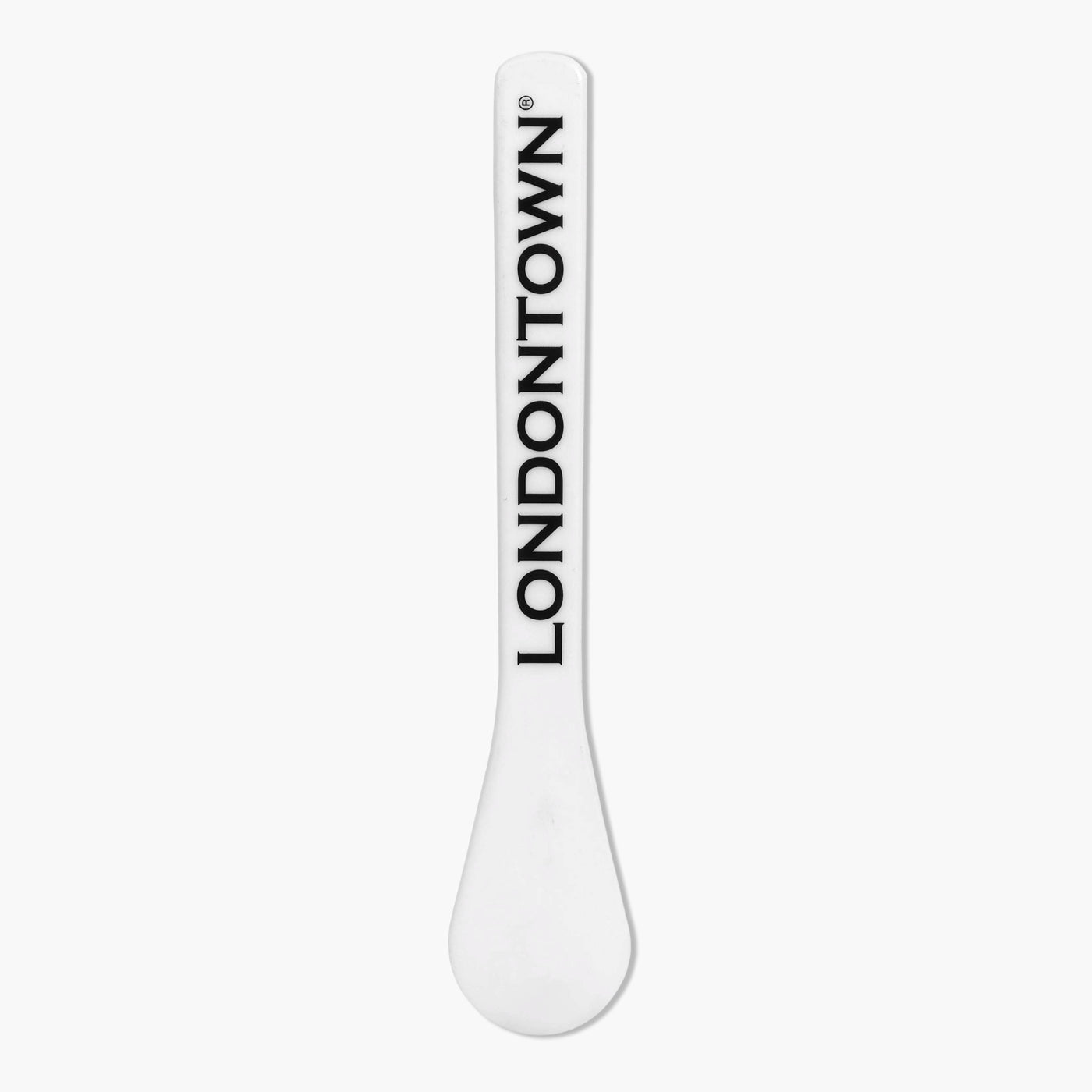 Close-up of a white Londontown Spatula with "LONDONTOWN" printed in black vertically.