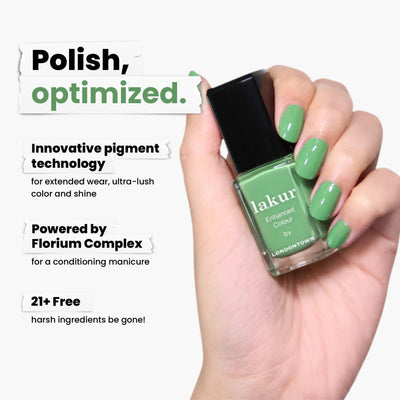 A hand displays LONDONTOWN's Secret Garden Posh polish in grassy green. It's an innovative, long-lasting pigment with Florium Complex, boasting a 16+ free vegan and cruelty-free formula without harsh ingredients.