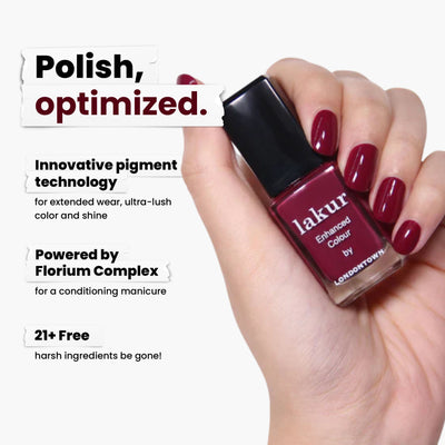 A hand with red nail polish holds a bottle of dark red LONDONTOWN's Guarded Jewel nail polish. The text highlights its pigment technology, Florium Complex, and vegan, cruelty-free formula free from 21+ harsh ingredients.