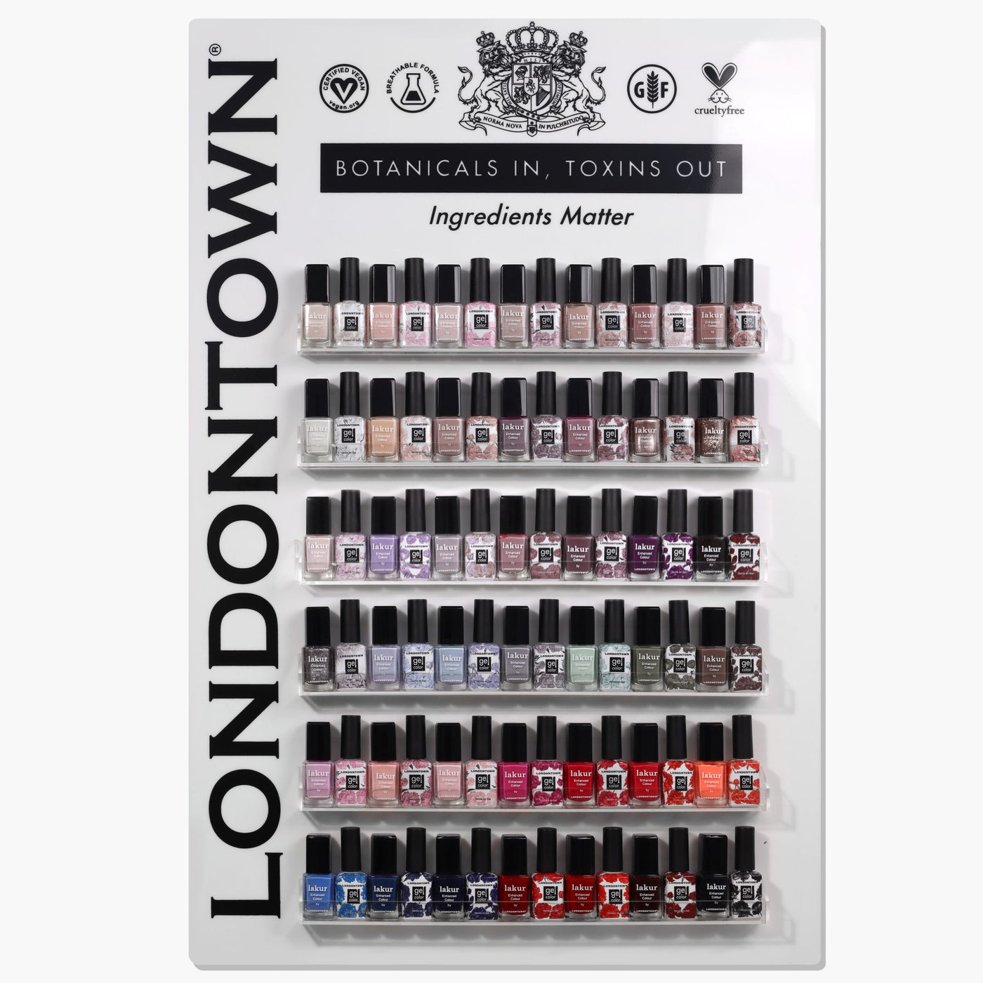 Display of LONDONTOWN Professional Wall Display w/Product (Lakur & Gel) nail polishes in various colors, arranged in rows on a white stand. The panel reads "BOTANICALS IN, TOXINS OUT" and "Ingredients Matter" along with some logos at the top.