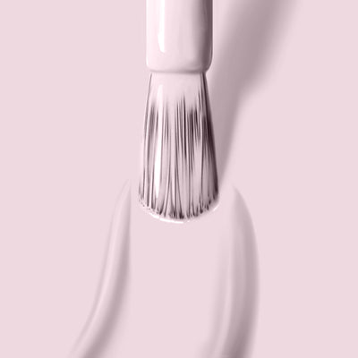 A close-up of a brush applying LONDONTOWN's "Afternoon Tea," a warm and cozy light pink crème nail polish.