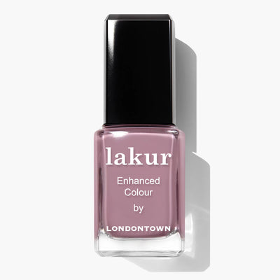 Here is a bottle of Bell Flower (Professional) nail polish by LONDONTOWN. The bottle is rectangular with a black cap and contains a muted, dusty pink nail polish enriched with the Londontown Florium Complex.