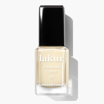 A nail polish bottle labeled "Buttercup (Professional) by LONDONTOWN" features a pastel yellow creme shade with a black cap and is a cruelty-free, vegan nail polish.