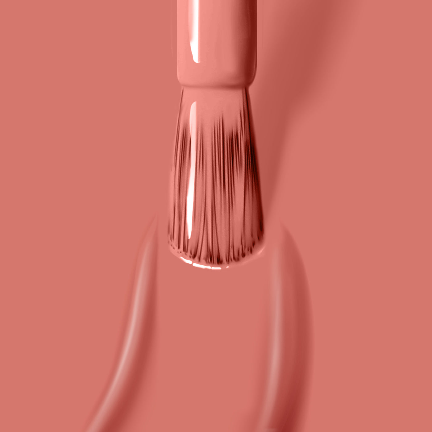 Close-up of a nail polish brush applying a smooth coat of LONDONTOWN's Cactus Coral vegan nail polish against a matching background.