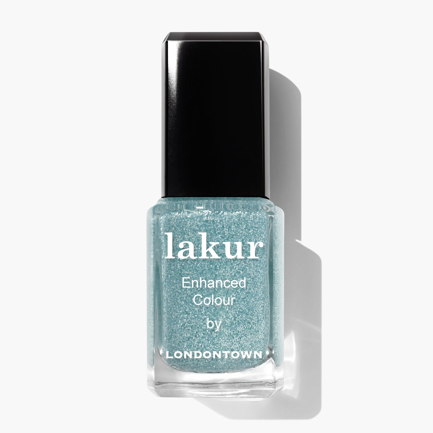 A bottle of LONDONTOWN Cheshire Plains cruelty-free nail polish in a shimmery light blue shade with a black cap and white text, perfect for adding a touch of elegance. Pair it with a clear sparkle top coat for extra shine.