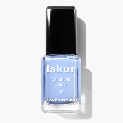 A bottle of Lakur nail polish named "Chuffed to Bits" by LONDONTOWN, featuring a black cap and a periwinkle crème blue color, with an impressive vegan cruelty-free formula.