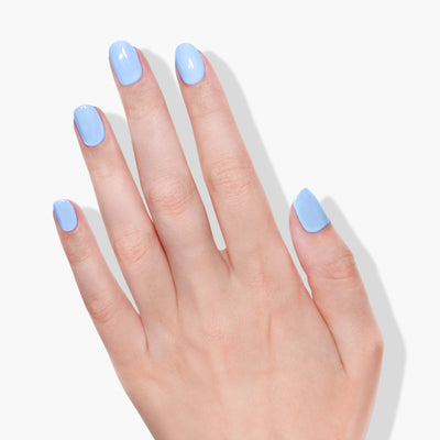 A hand with neatly manicured nails painted in the glossy Chuffed to Bits color by LONDONTOWN is spread open against a white background.