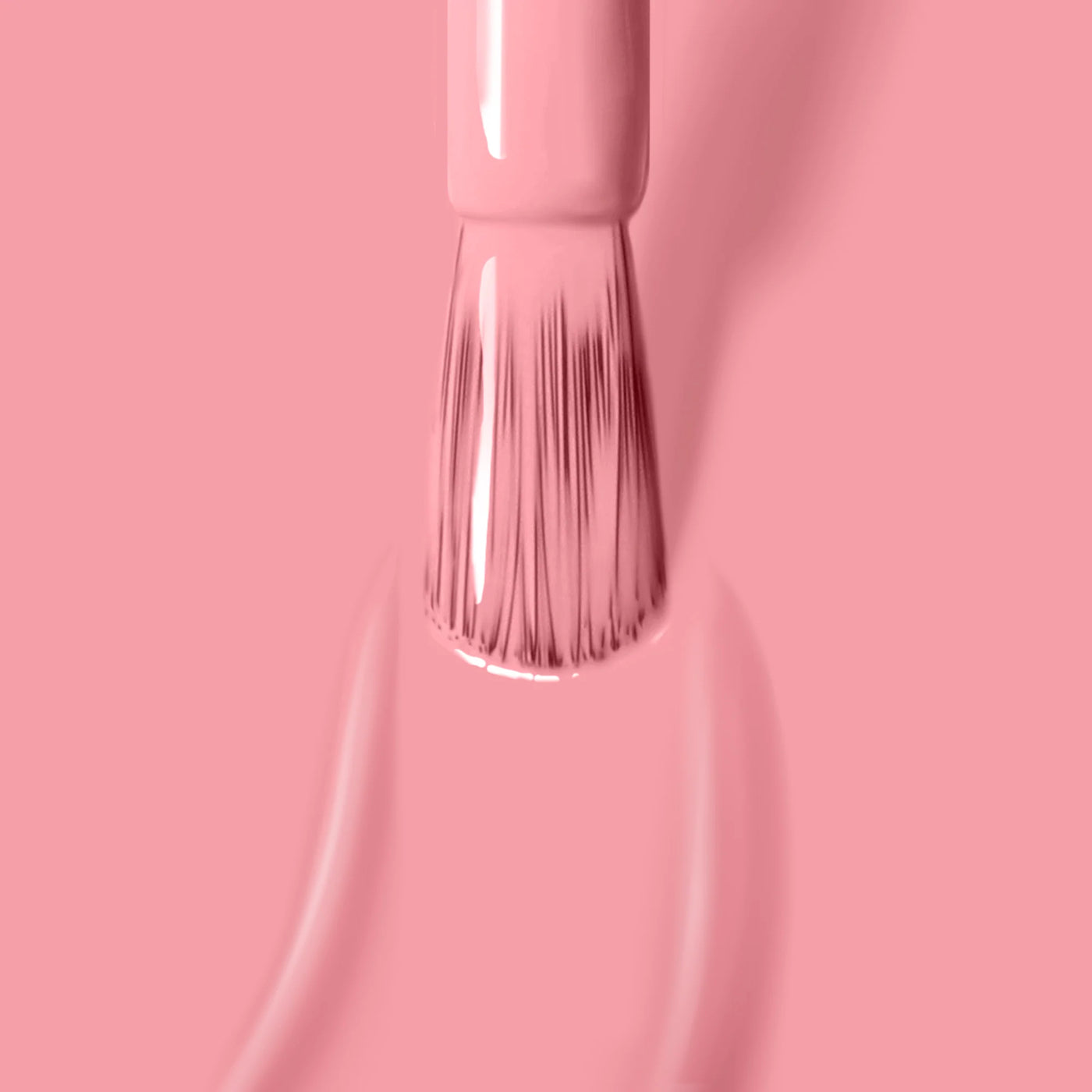 A brush applies LONDONTOWN's Desert Flower (Professional) cruelty-free nail polish on a matching pink background.