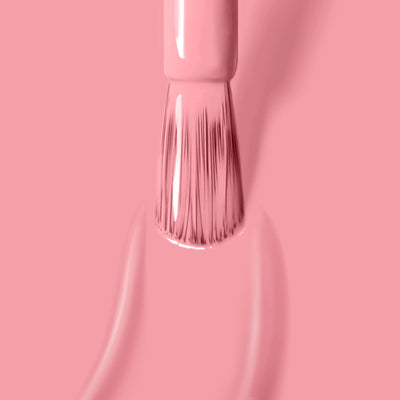 A brush applies LONDONTOWN's Desert Flower (Professional) cruelty-free nail polish on a matching pink background.