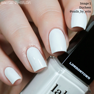 Close-up of a hand showcasing nails adorned with LONDONTOWN's Duchess pure crème white nail polish, perfect for a chic French manicure.