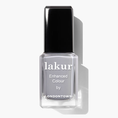 A bottle of LONDONTOWN's Earl Grey Lakur Enhanced Colour nail polish, featuring a black cap and a clear body that showcases grey-colored, cruelty-free vegan polish.
