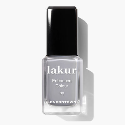 A clear bottle of LONDONTOWN's Earl Grey (Professional) nail polish with a black cap, labeled "Enhanced Colour," stands out against a white background. Proudly vegan and cruelty-free, it's the perfect choice for conscious beauty enthusiasts.