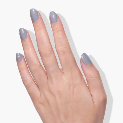 A hand with nails adorned in the sleek grey, cruelty-free LONDONTOWN Earl Grey (Professional) nail polish is shown against a plain white background.