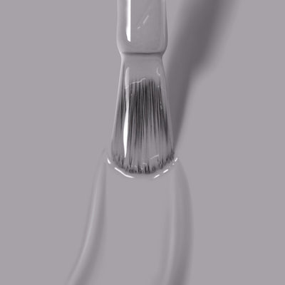 Close-up of a LONDONTOWN paintbrush with white bristles dipped in Earl Grey nail polish on a gray background.