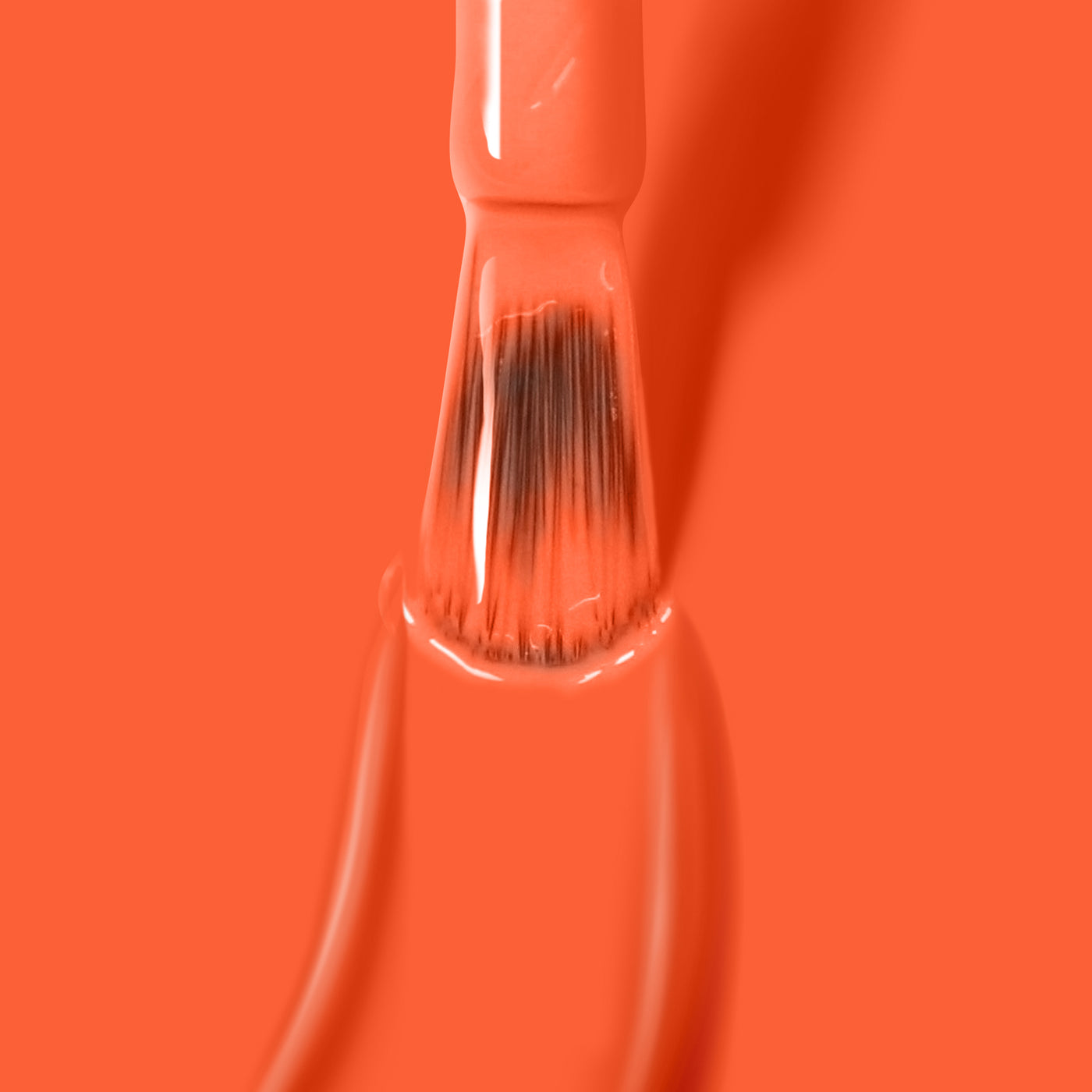 A brush dipped in vibrant LONDONTOWN's Flashback gel color, partially submerged in a pool of neon orange nail polish.