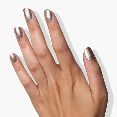 A hand adorned with LONDONTOWN's Gilded nail polish on all five nails, gleaming against a plain white background. This PETA certified, vegan cruelty-free polish adds an elegant touch to any look.