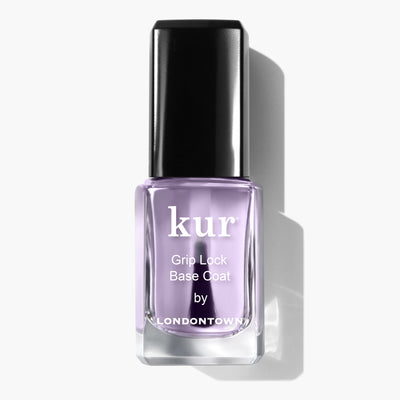 A bottle of LONDONTOWN's Grip Lock Base Coat nail polish, perfect for your next mani, features a black cap and offers a sleek lavender hue.