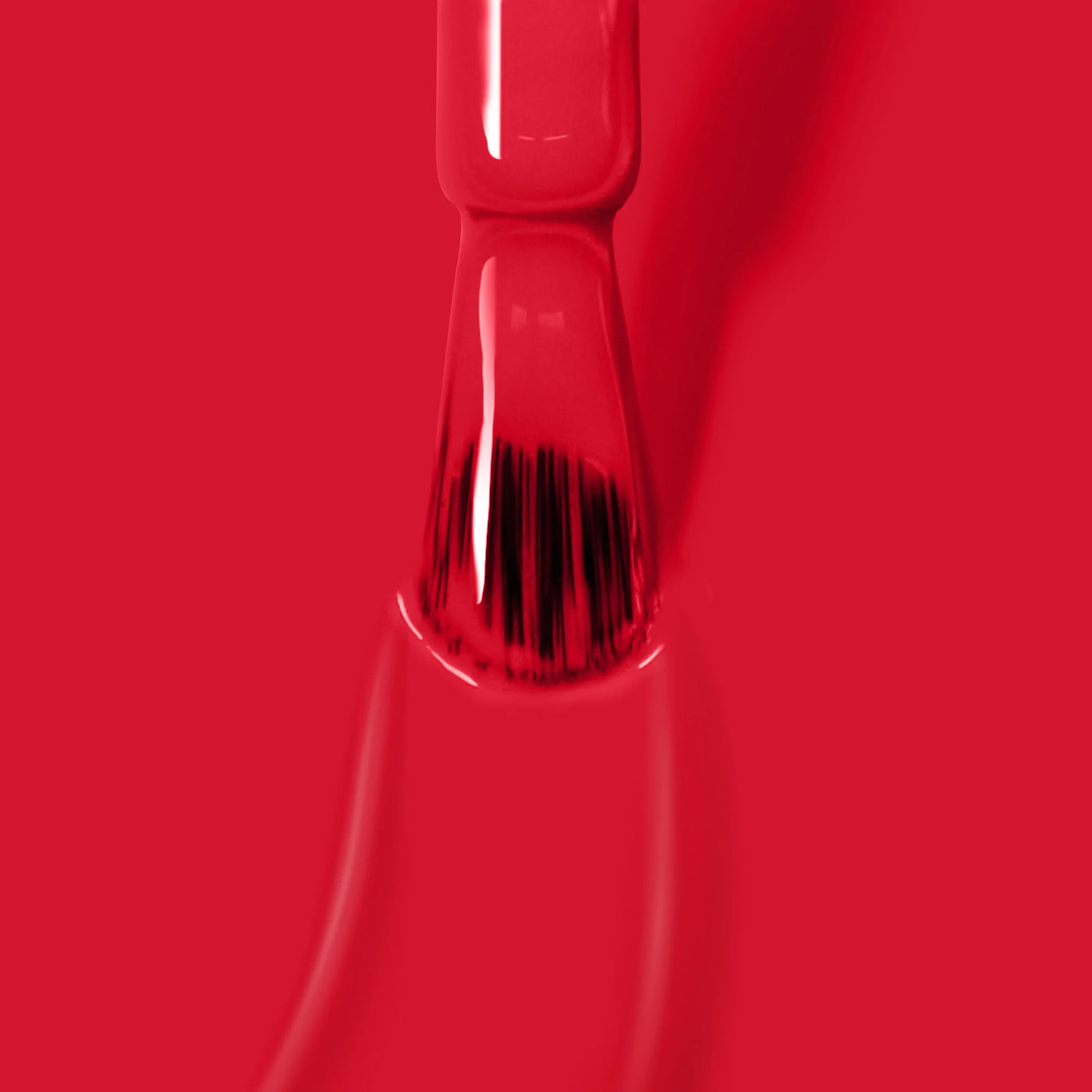 Close-up of the brush applying LONDONTOWN's glossy, cruelty-free, vegan "Guilty Pleasure (Professional)" red nail polish.