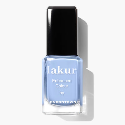 A bottle of LONDONTOWN's "In the Clouds" vegan nail polish in a light blue shade with a black cap, perfect for a cruelty-free manicure.