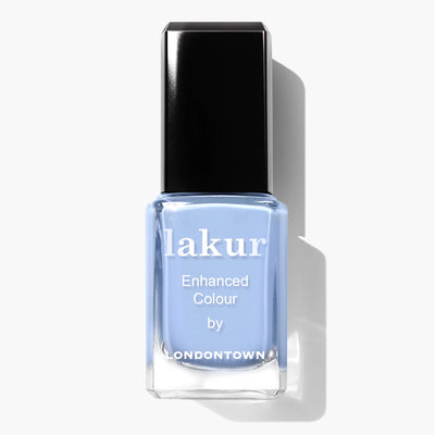 A bottle of light blue nail polish named "In the Clouds (Professional)" by LONDONTOWN, featuring "Enhanced Colour by Londontown" on the label. This cruelty-free, vegan formula comes with a black, glossy cap, ensuring both beauty and ethics are in your hands.