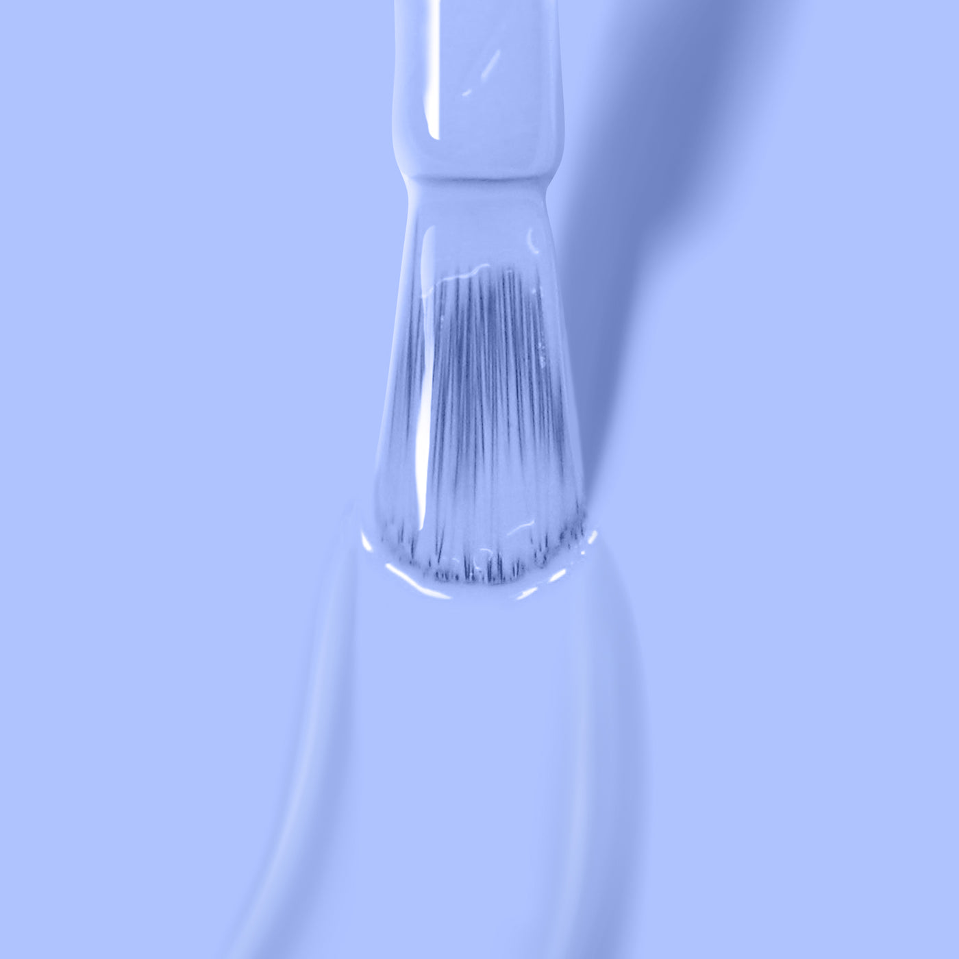 A close-up of a brush applying a smooth layer of light blue, vegan, and cruelty-free "In the Clouds" nail polish by LONDONTOWN on a surface.