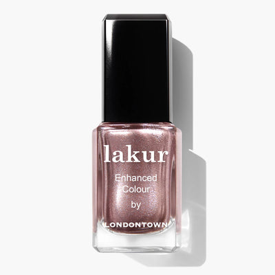 A bottle of LONDONTOWN's Kissed by Rose Gold (Professional) nail polish in a metallic rose gold shade with a black cap. This vegan, cruelty-free, PETA certified beauty is the perfect choice for a chic and conscientious manicure.