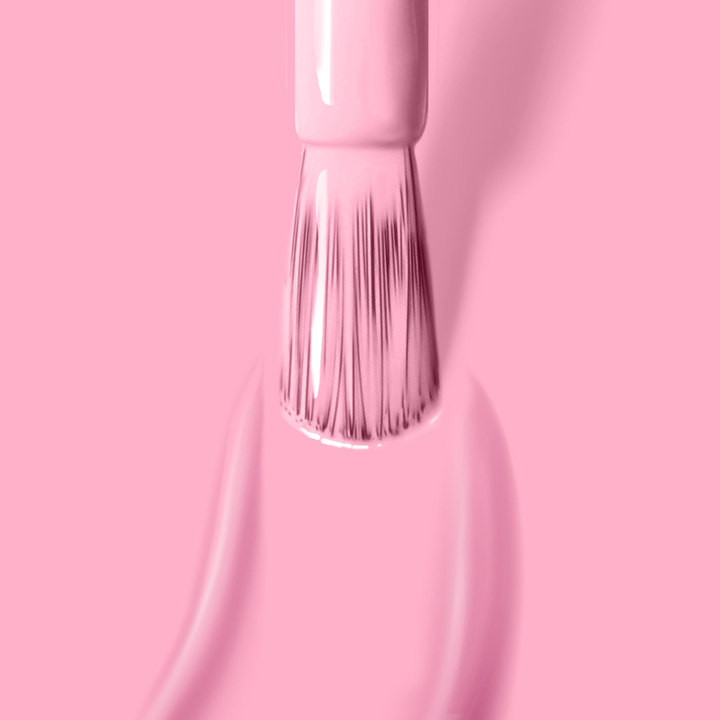 A brush applies LONDONTOWN's Lemonade Pop, a cruelty-free, light pink nail polish, on a matching muted pink background, with smooth strokes and even coverage.