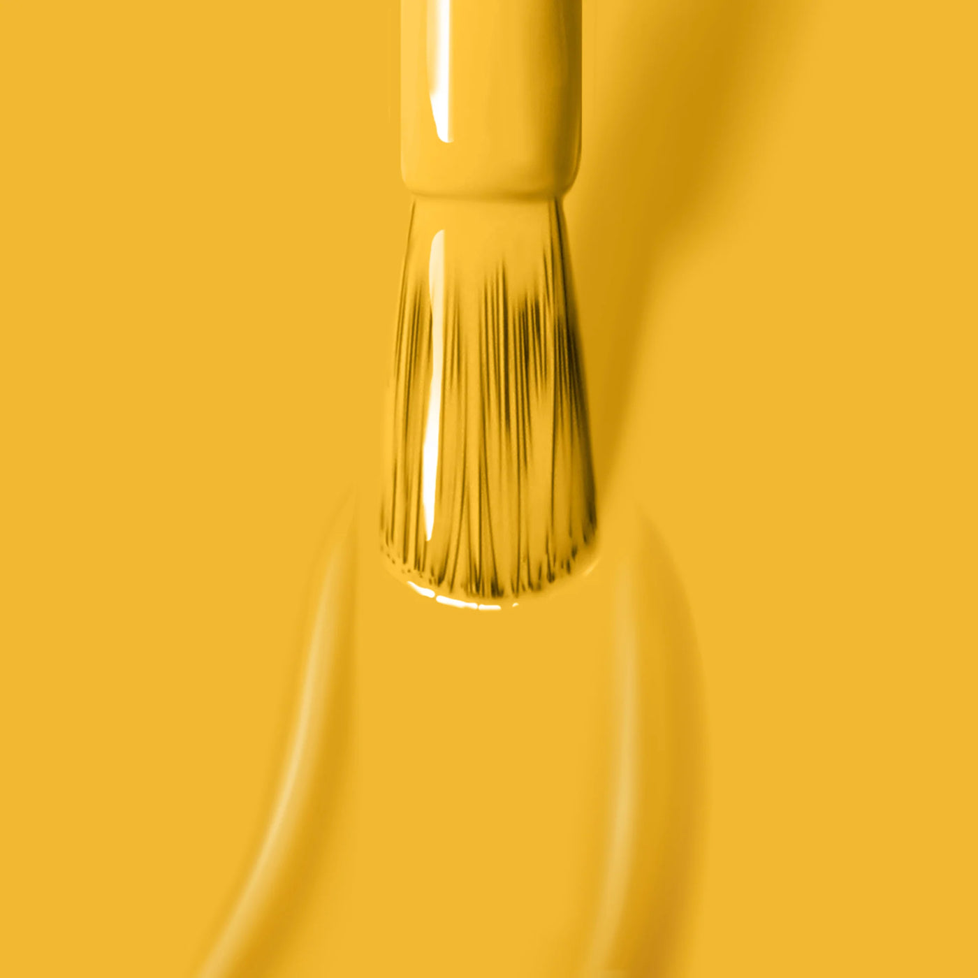 Close-up of a paintbrush applying a smooth coat of Mango (Professional) by LONDONTOWN, a cruelty-free paint.