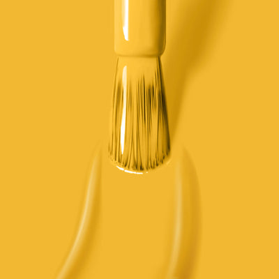 Close-up of a paintbrush applying a smooth coat of Mango (Professional) by LONDONTOWN, a cruelty-free paint.