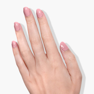 A hand with manicured nails painted with LONDONTOWN's Mauve Over (Professional) is shown against a white background, highlighting the elegance of vegan, cruelty-free beauty.