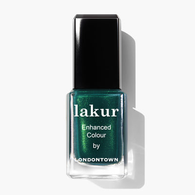 A bottle of LONDONTOWN Lakur nail polish, named "Mistletoe," in a mesmerizing deep emerald green shade accented with a subtle gold shimmer, featuring a black cap and white text on the front.