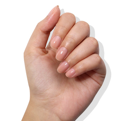 A hand with neatly manicured nails, showcasing a hint of color from LONDONTOWN's Perfecting Nail Veil #4, set against a white background.