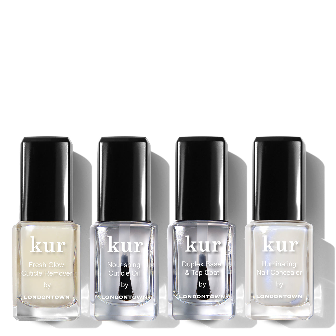 Four nail care bottles are displayed in a row. The labels read: LONDONTOWN Fresh Glow Cuticle Remover, LONDONTOWN Nourishing Cuticle Oil, LONDONTOWN Duplex Base & Top Coat, and LONDONTOWN Illuminating Nail Concealer from the Nail Care + Concealer System.