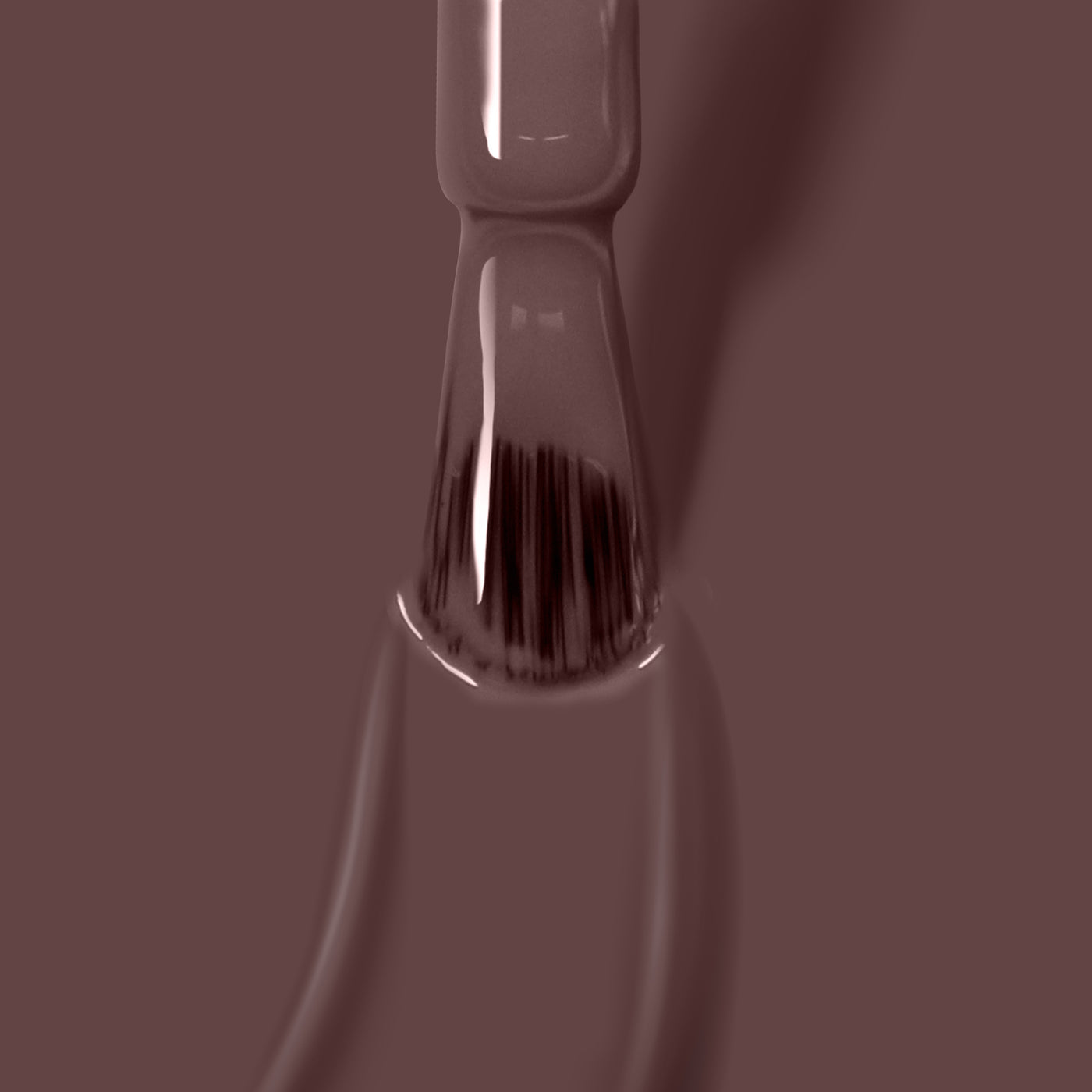 Close-up of a LONDONTOWN Natural Charm gel color nail polish brush, dipped in a creamy mauve purple shade. This vegan, cruelty-free formula ensures your nails look stunning and feel great.