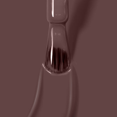 Close-up of a LONDONTOWN Natural Charm gel color nail polish brush, dipped in a creamy mauve purple shade. This vegan, cruelty-free formula ensures your nails look stunning and feel great.