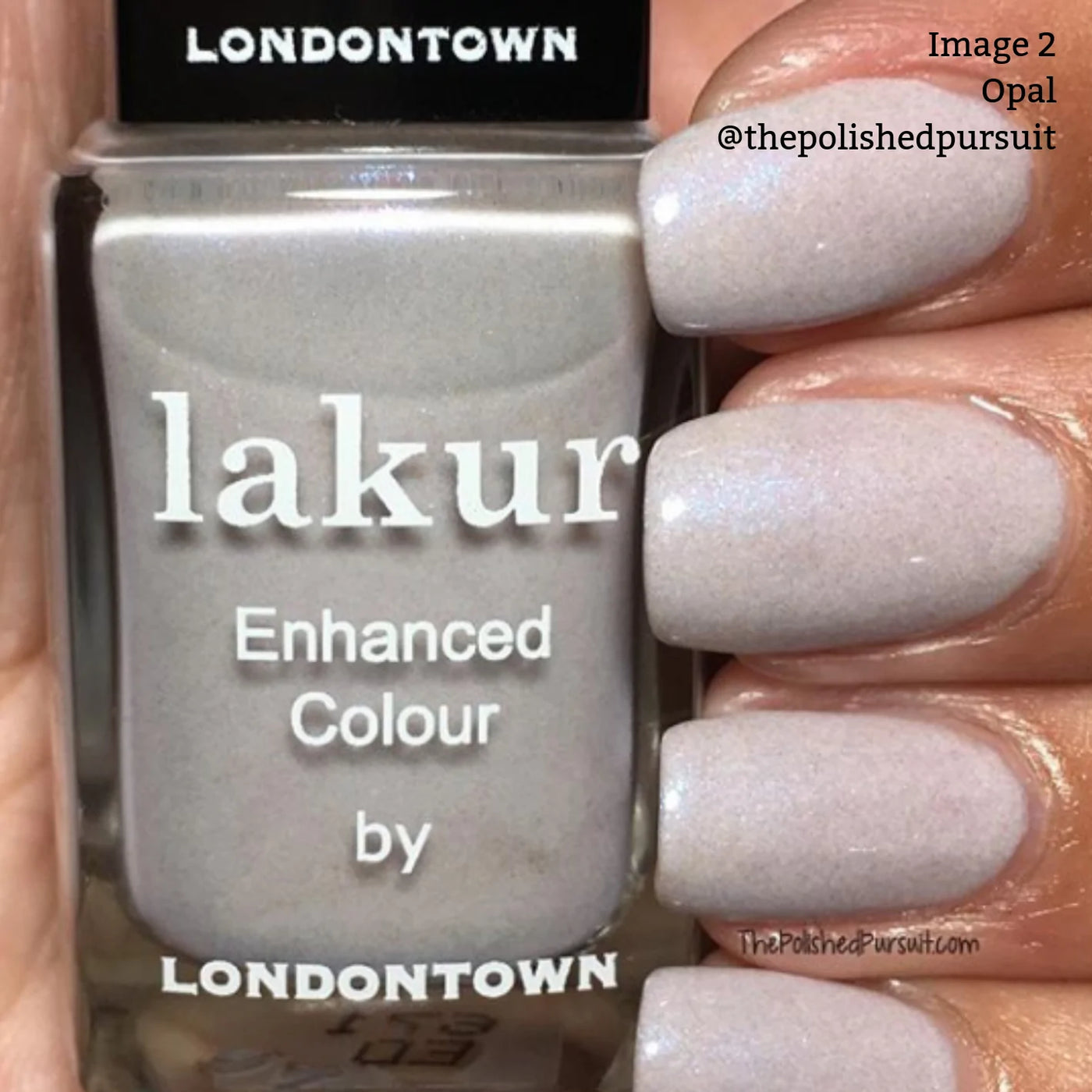 Close-up of a hand with nails painted in a light opal color, holding a bottle of LONDONTOWN Opal (Professional) shimmering lilac nail polish.