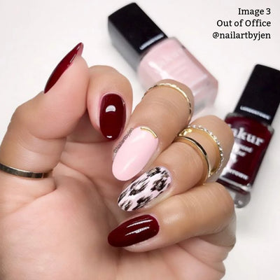 A manicured hand showcases red, pastel pink, and animal print nail designs, adorned with three rings. Two bottles of LONDONTOWN's vegan, cruelty-free nail polish from the "Out of Office (Professional)" collection are visible in the background. Text reads "Image 3 Out of Office @nailartbyjen".