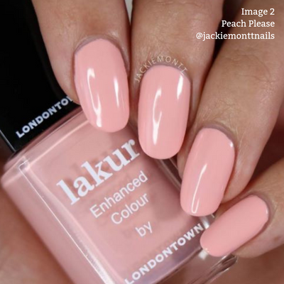 Close-up of a hand with neatly painted nails in a pale peach creme shade, holding a bottle of LONDONTOWN's Lakur nail polish. The text reads “Image 2 Peach Please @jackiemonttnails” highlighting the vegan, cruelty-free formula.