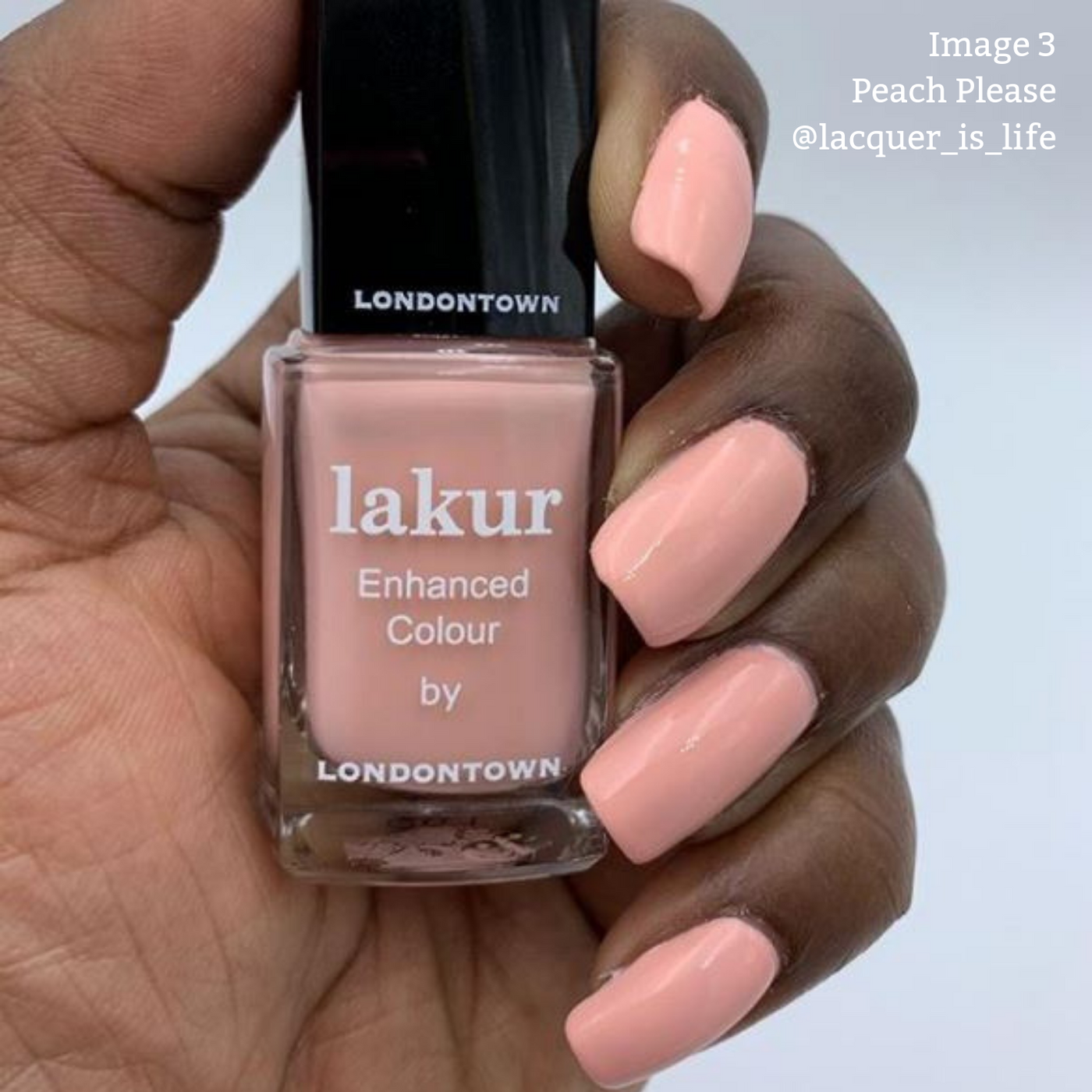 A hand with peach-colored nail polish holds a bottle of LONDONTOWN's Lakur Enhanced Colour in the shade "Peach Please," celebrated for its vegan and cruelty-free formula. Text in the top right says "Image 3 Peach Please @lacquer_is_life.
